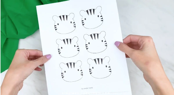 hands holding handprint tiger craft template 
