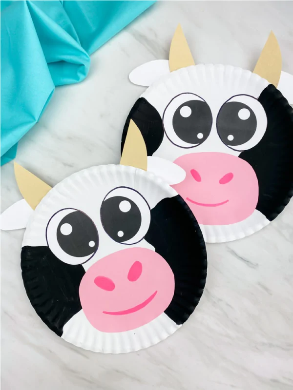 two paper plate cows