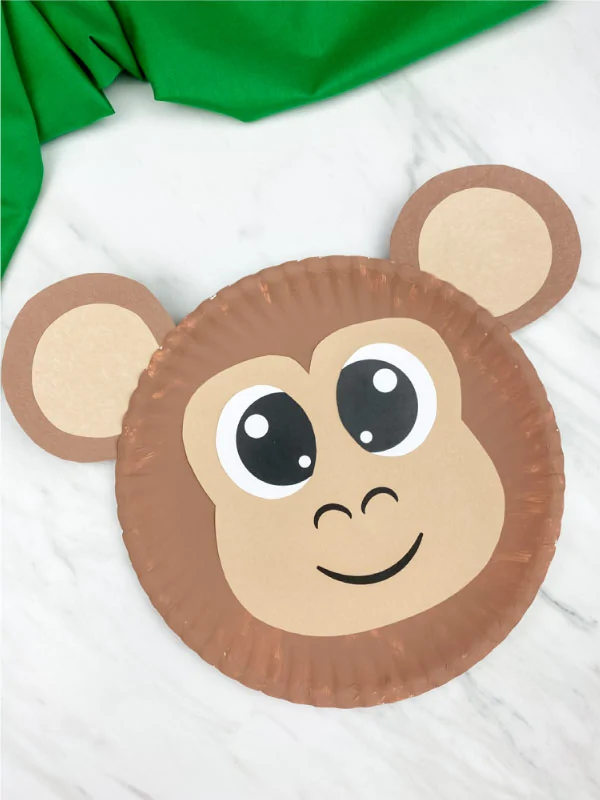 paper plate monkey on marble background with green fabric