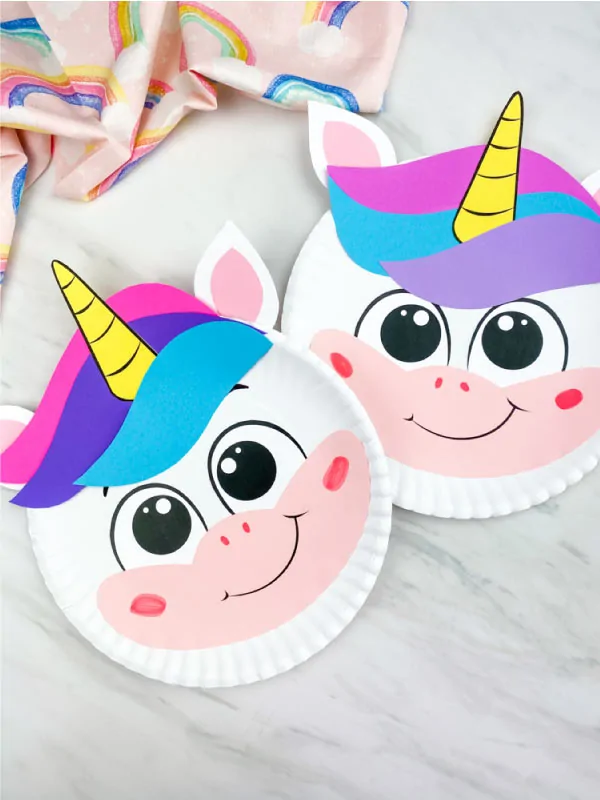 closeup of two paper plate unicorn crafts