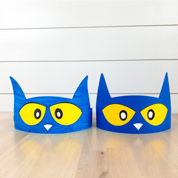 one colored in pete the cat headband, one paper craft pete the cat headband on wood table with shiplap background 