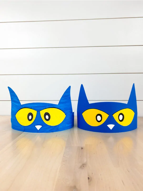 two Pete the Cat paper headbands on wood table with shiplap background 