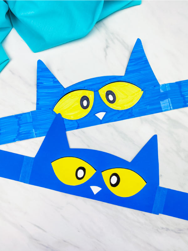 two flat Pete the Cat headbands stacked vertically on each other with marble background and aqua fabric 