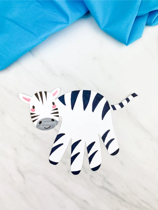 hand print zebra on marble background with blue fabric 