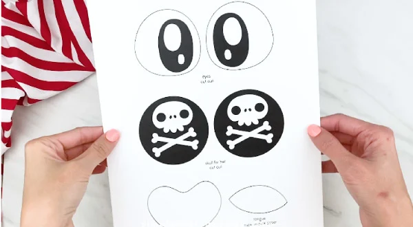 hands holding paper plate pirate template 
