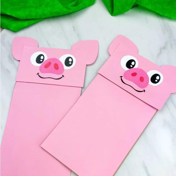 two pig puppet crafts on marble background 