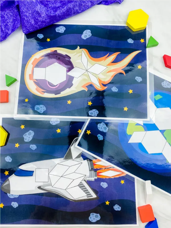 comet, earth and spaceship pattern block mats with pattern blocks scattered 