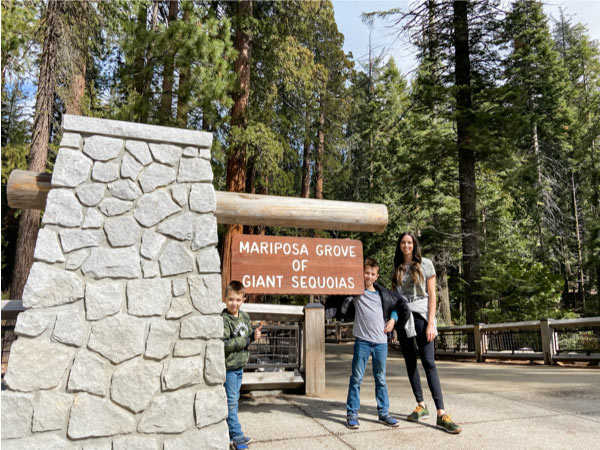 mom with two kids at sign at Mariposa Grove 