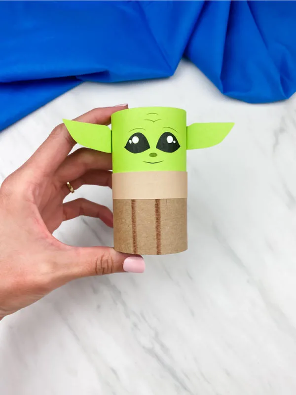 hand holding baby yoda toilet paper roll craft 