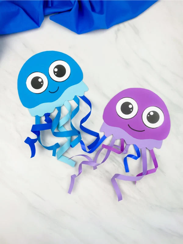 blue and purple jellyfish craft on marble background 