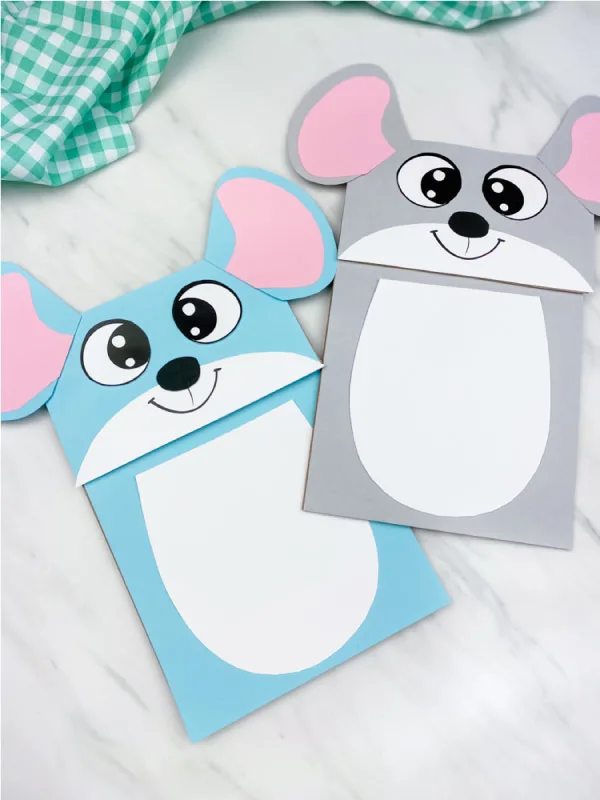 blue and gray mouse puppet craft on marble background with green checkered fabric