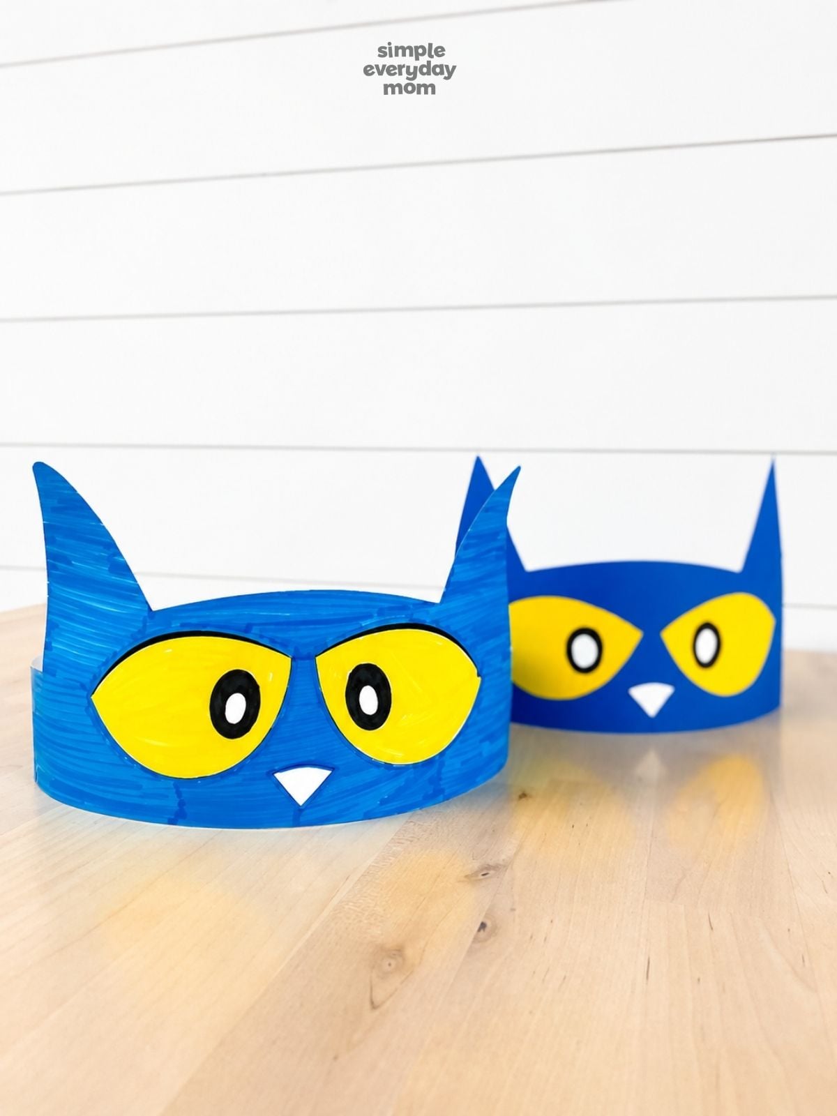 Close-up of two blue Pete the Cat headbands, with the hand-colored version in front.