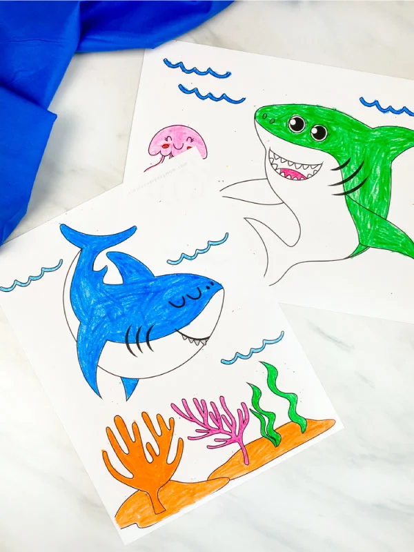 blue and green great white shark coloring pages on marble background with blue fabric