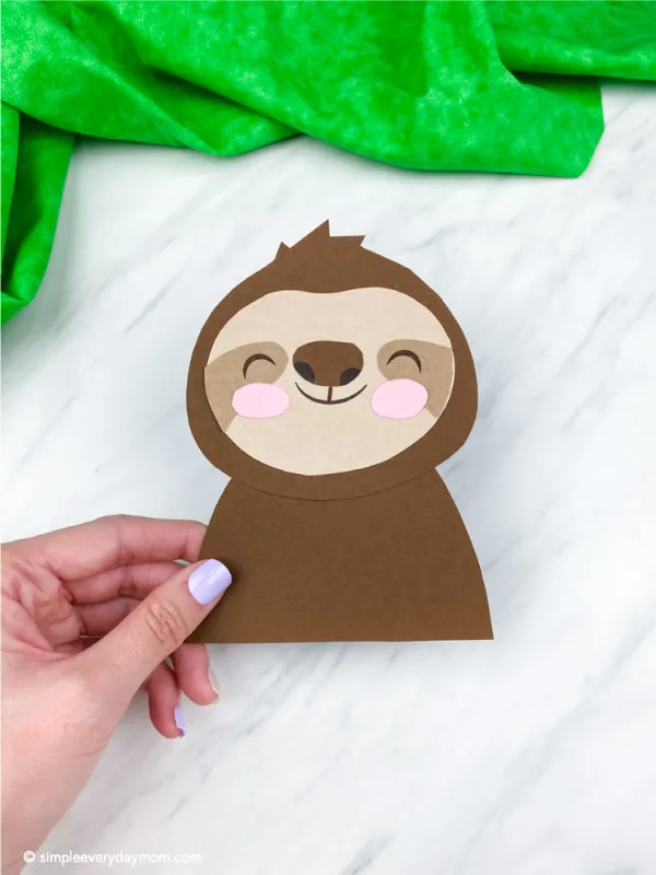 hand holding paper sloth craft