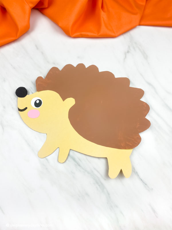 light brown paper plate hedgehog craft at an angle