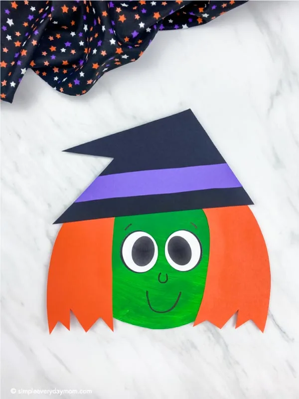 dark green and orange haired paper plate witch