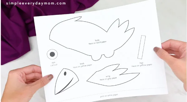 hands holding crow craft template