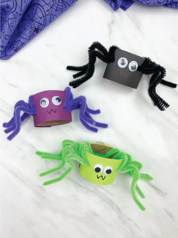 black, purple and green pipe cleaner spiders