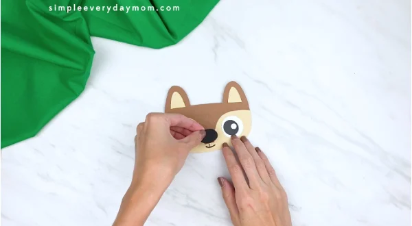 hands gluing nose onto paper squirrel head