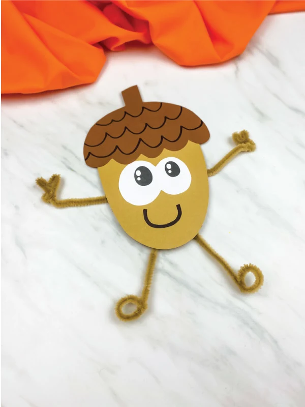 paper acorn craft with brown pipe cleaner arms and legs