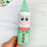 hand holding elf toilet paper roll craft