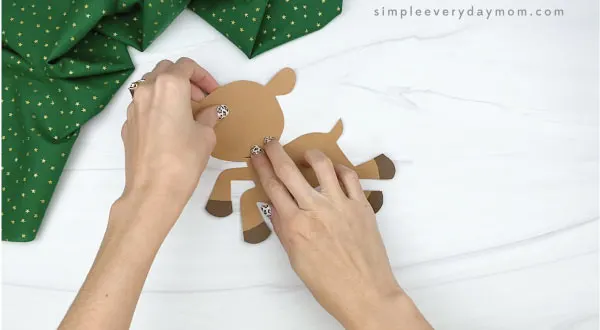 hands gluing head to paper rudolph craft