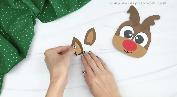 hand gluing inner ear to outer ear of reindeer Christmas card