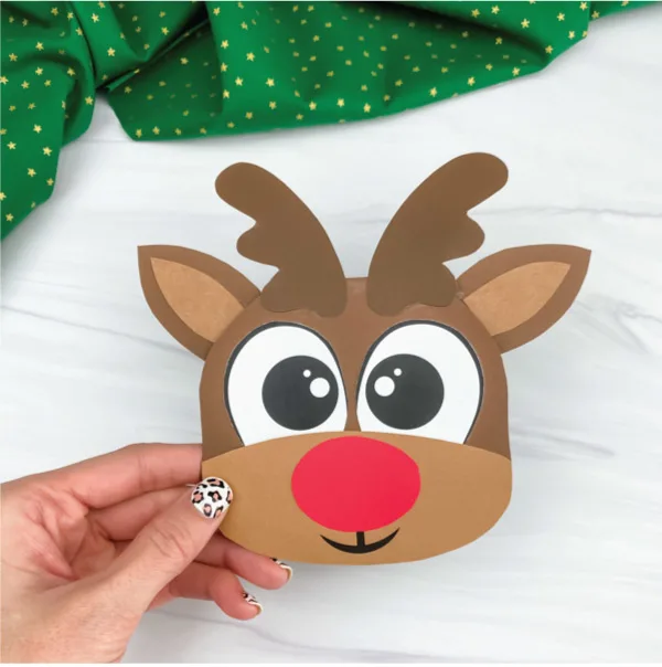 hand holding reindeer Christmas card