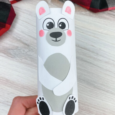 hand holding toilet paper roll polar bear craft