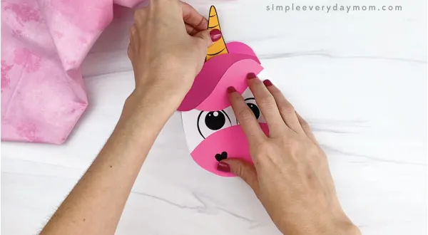 hand gluing horn onto unicorn card craft