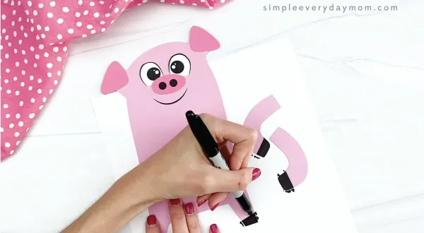 hand drawing hooves onto pig valentine craft