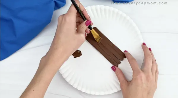 hand painting popsicle sticks dark brown