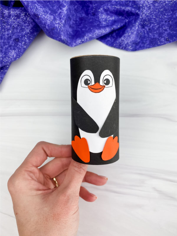 hand holding toilet paper roll penguin craft