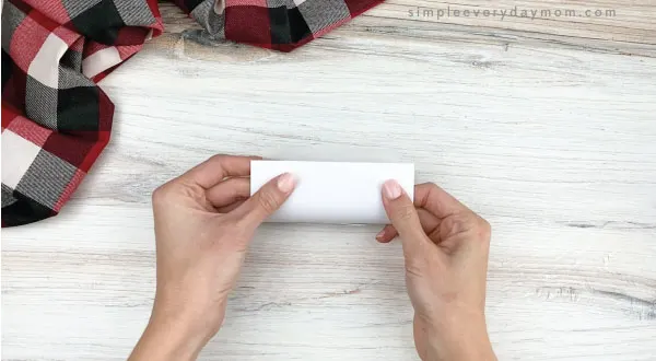 hands wrapping polar bear template around toilet paper roll
