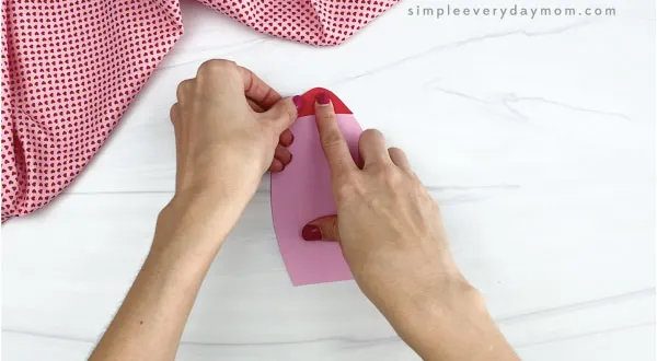 hands gluing tip to rocket valentine craft