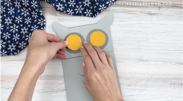 hands yellow gray circles to paper bag owl craft