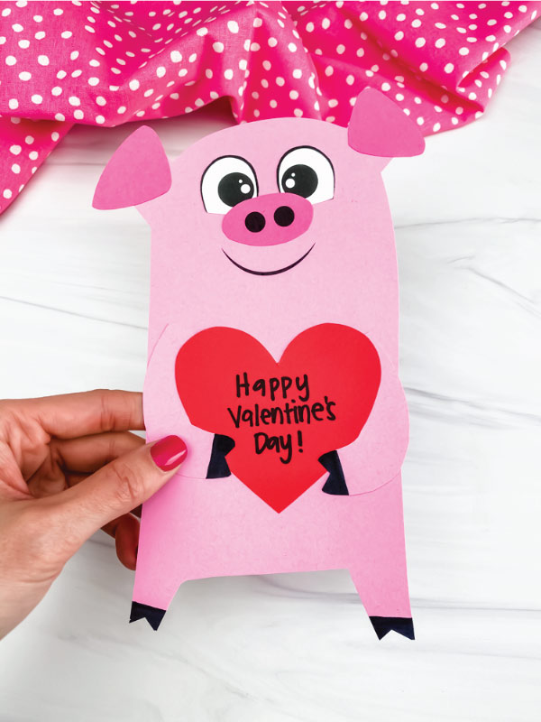 hand holding valentine pig craft