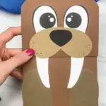 hand holding paper bag walrus craft
