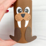 hand holding toilet paper roll walrus craft