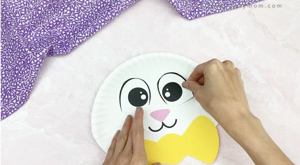 hand gluing eyes to paper plate Easter bunny craft