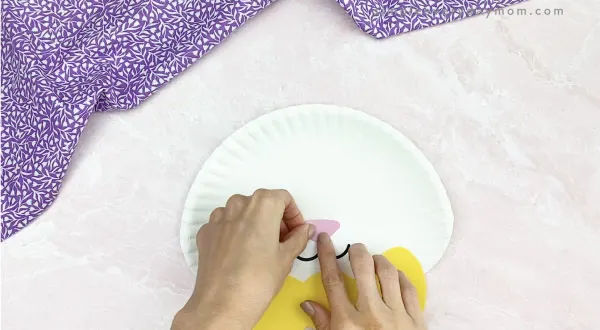 hand gluing nose to paper plate Easter bunny craft