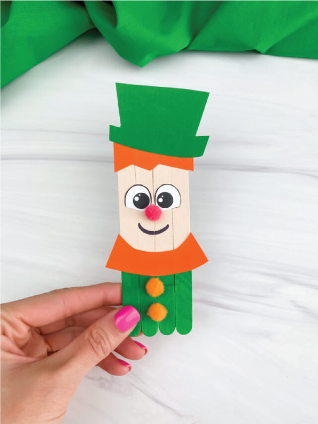 hand holding popsicle stick leprechaun craft