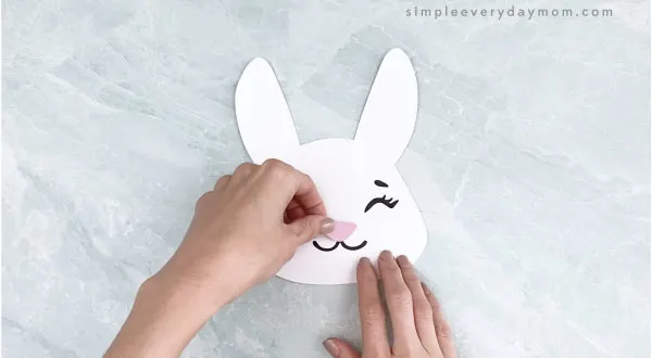 hands gluing nose to Easter bunny headband craft