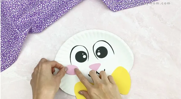 hand gluing cheeks to paper plate Easter bunny craft
