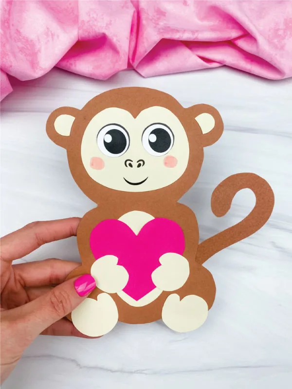 hand holding monkey valentine craft
