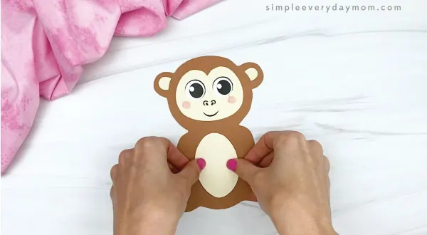 hand gluing belly to monkey valentine craft