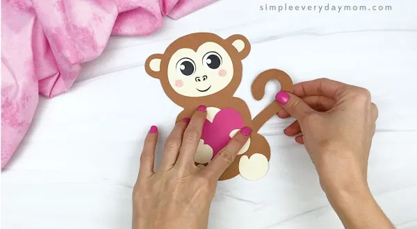 hand gluing tail to monkey valentine craft