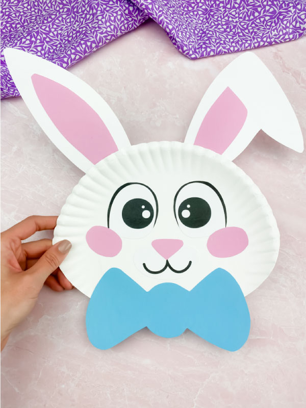 hand holding paper plate Easter bunny