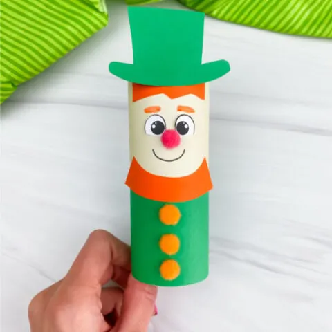 hand holding toilet paper roll leprechaun craft