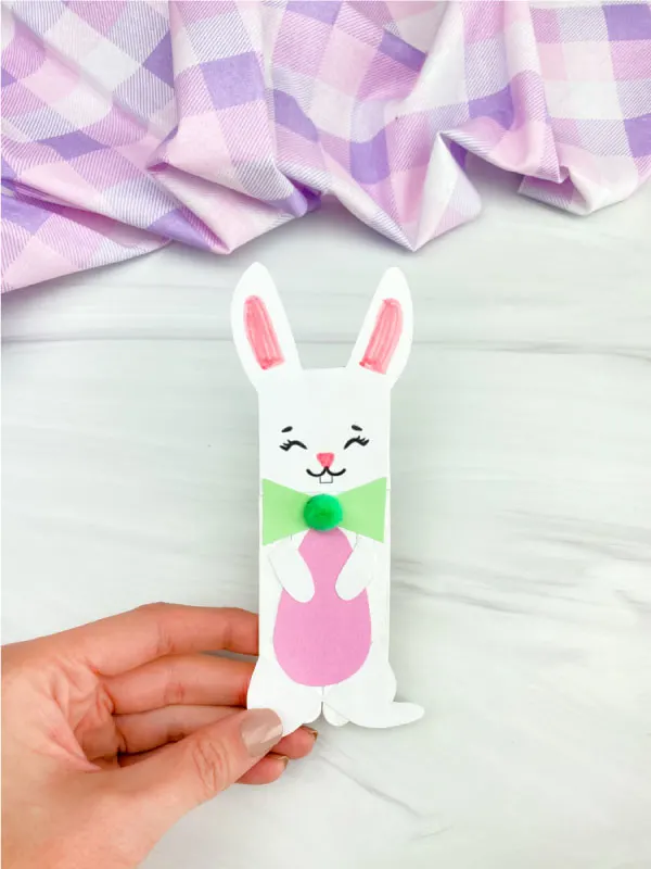 hand holding popsicle stick Easter bunny craft